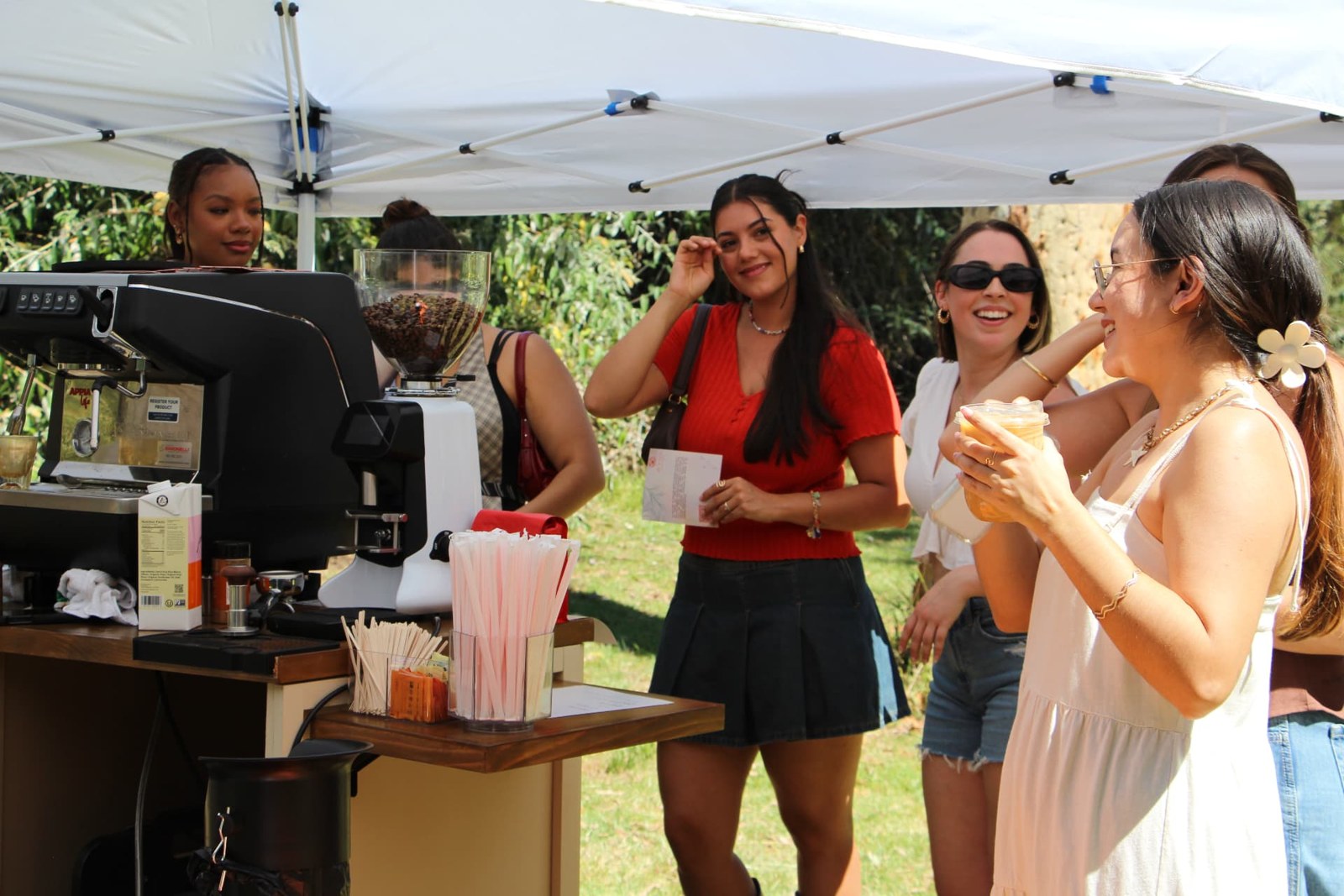 Guests gathering around the Ayni Café coffee cart at an outdoor event